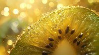 Fresh juicy kiwi slice with water drops and golden bokeh lights in background, macro photography showing detailed texture and seeds in natural lighting.