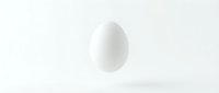 White egg floating above surface on clean minimalist background for cooking and nutrition concepts.