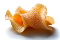 Crispy potato chip with distinctive wavy texture and rippled surface casting soft shadow on white background, macro food photography showing detailed ridges.