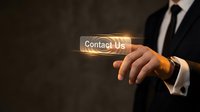 Professional businessman in suit pressing glowing Contact Us button with finger, customer service and business communication concept for websites.
