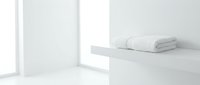 Folded white towels stacked on minimalist shelf in bright, clean bathroom interior with natural light from window.