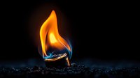 Dramatic close-up of burning match on dark background with orange flame and blue accent, artistic macro photography showing fire reflection on matchstick surface.
