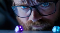 Close up portrait of mature bearded man in glasses looking intensely at glowing gaming dice with blue and purple lights, creating dramatic atmosphere.