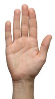 Open palm hand gesture isolated on white background showing stop sign or high five motion for communication and body language concepts.