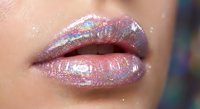 Glossy holographic lips with iridescent shimmer and rainbow reflections on smooth skin for beauty and cosmetics applications.