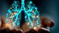 Glowing turquoise and orange human lungs held in caring hands against dark background, representing respiratory health, medical science and healing energy.