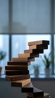 Wooden blocks stacked in spiral staircase formation symbolizing growth, progress and step-by-step achievement in modern office environment.