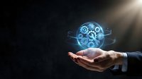 Businessman hand holding glowing digital brain with gears and circuits representing artificial intelligence and machine learning technology concepts.