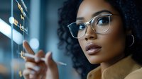 Young African American businesswoman with glasses touching futuristic holographic interface in modern office environment for technology presentations.