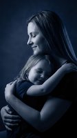 Caucasian mother tenderly hugging her sleeping little daughter in a dark blue toned studio portrait, expressing love and maternal bond.