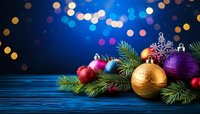 Festive Christmas composition with gold and purple baubles, pine branches on blue wooden table with bokeh lights background.