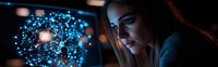 Young woman looking at glowing blue digital network visualization on dark screen, dramatic side lighting creates moody atmosphere for technology concept.