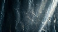 Dramatic dark blue ice surface with intricate cracks and crystalline textures creating abstract frozen landscape patterns for winter design projects.