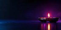 Traditional clay diya lamp with glowing flame against dark background with purple and blue bokeh lights, celebrating Diwali festival with reflection.