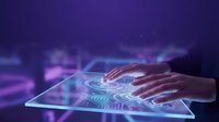 Professional hands interacting with futuristic holographic interface on tablet displaying glowing digital circuits and data visualization technology.