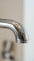 Modern chrome bathroom faucet spout with polished finish in contemporary home interior design for plumbing renovation projects.