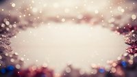 Festive holiday background with warm bokeh lights and decorative ornaments creating magical atmosphere for seasonal celebrations and winter events.