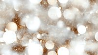 Festive bokeh lights creating magical holiday atmosphere with soft white and golden glowing circles on blurred background with sparkling effect.