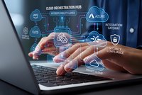 Businessman hands typing on laptop with cloud computing network icons and digital technology interface overlay for modern business solutions.