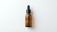 Amber glass dropper bottle with black pipette cap on white background, suitable for essential oils, serums, and cosmetic product packaging.