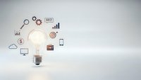 Glowing light bulb with digital marketing icons on clean background for business innovation and strategy concepts.