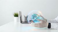 Businessman in white shirt holding transparent globe with glowing blue digital network interface, representing global connectivity, data security, and technology innovation for business solutions.