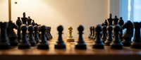 Chess game in progress with wooden pieces on board showing strategic gameplay and competition for tournaments and intellectual challenges.