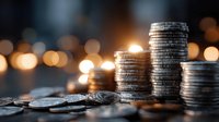 Stacked coins on wooden surface with warm bokeh lights background creating financial growth and investment concept for business presentations.