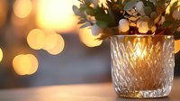 Crystal glass vase with diamond pattern catching warm golden bokeh lights in background, creating cozy atmospheric mood for home decor and celebrations.