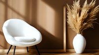 Modern white round chair and pampas grass in ceramic vase against beige wall with window shadow creating minimalist interior design composition.