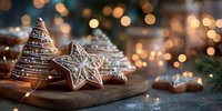 Festive gingerbread cookies with white icing on wooden board, warm bokeh lights creating cozy holiday atmosphere for seasonal baking and Christmas celebrations.