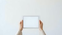 Hands holding blank tablet device with empty screen against white background, suitable for app mockups, technology presentations, and digital product advertising.