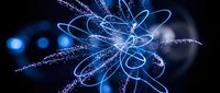 Glowing neon blue atomic structure with swirling energy particles and light trails on dark background. Suitable for science, technology, physics, and digital innovation concepts.