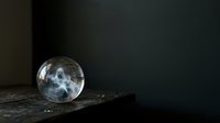 Crystal sphere with moon reflection on dark stone surface against black background, suitable for mystical and spiritual design projects.