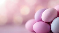 Pastel pink and white Easter eggs on blurred bokeh background with soft dreamy lighting creates gentle spring holiday atmosphere.