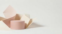 Minimalist geometric shapes in soft pink and beige tones create elegant product display podium. Modern abstract composition for cosmetic branding and showcase.