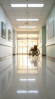 Empty wheelchair in bright hospital corridor with polished floors and natural light streaming through windows for healthcare facility design.
