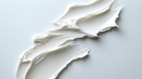 Elegant white cream texture with smooth flowing waves and soft peaks creates minimalist abstract background for cosmetic and skincare product presentation.