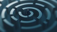 Silhouette of businessman standing in center of dark circular maze pattern, representing leadership challenges and strategic decision making in corporate world.