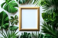 Golden frame surrounded by tropical green monstera leaves and palm fronds on white background. Mockup for artwork, quotes or photography display.