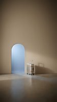 Minimalist interior with arched doorway and modern bar cart in warm beige tones creating serene architectural space for contemporary design projects.