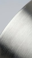 Brushed stainless steel surface with linear grain texture and metallic finish for industrial design applications.