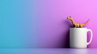 Playful brown dinosaur figurine sitting on white coffee mug against vibrant gradient background from blue to pink, minimal composition for creative design projects.