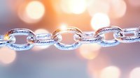 Silver metallic chain links with sparkling glitter texture against soft bokeh lights background for jewelry design and luxury accessories concepts.