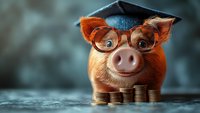 Smiling piggy bank wearing graduation cap and glasses with stacked coins, representing education savings and financial literacy concept on blurred background.