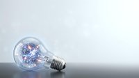 Incandescent light bulb with glowing blue filament on white background, isolated for design and creative projects.
