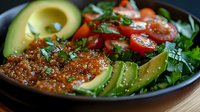 Fresh salmon fillet with sliced avocado, cherry tomatoes and mixed greens in black bowl. Healthy meal prep concept for ketogenic diet and clean eating lifestyle.