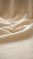Closeup of natural linen fabric with soft folds and gentle waves, showcasing texture and light for textile, fashion, and interior design projects.