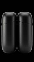 Pair of black capsule-shaped containers with rounded tops and cylindrical bodies, isolated on transparent background. Ready for design use on product packaging, labels, stickers, and print-on-demand applications.