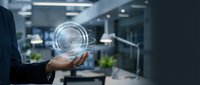 Businessman holding digital fingerprint hologram in modern office environment for identity verification and cybersecurity solutions.